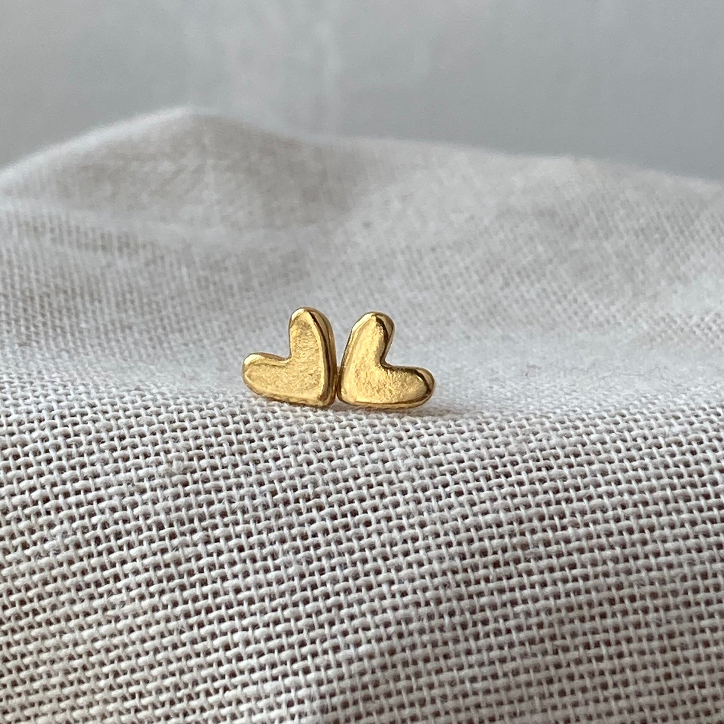 Tiny gold heart studs