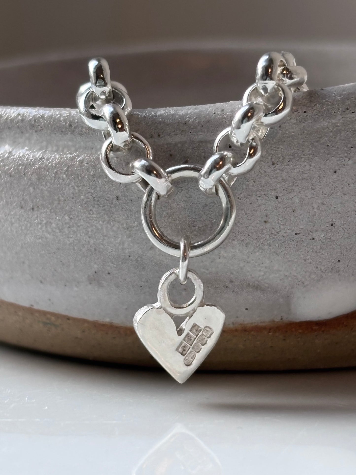 Heavy silver belcher charm necklace.