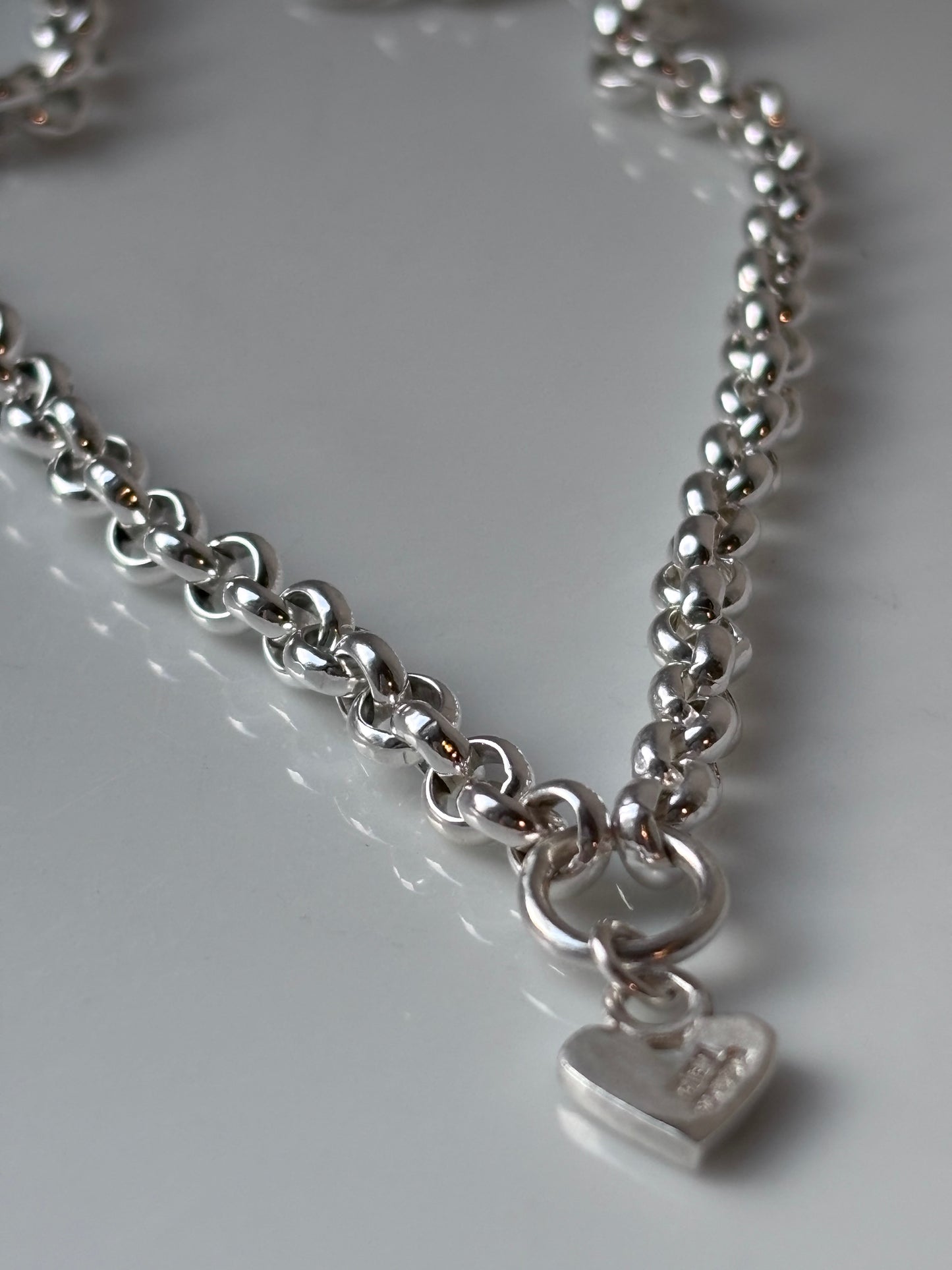 Heavy silver belcher charm necklace.