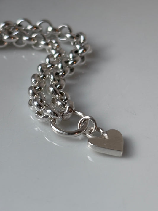 Heavy silver belcher charm necklace.