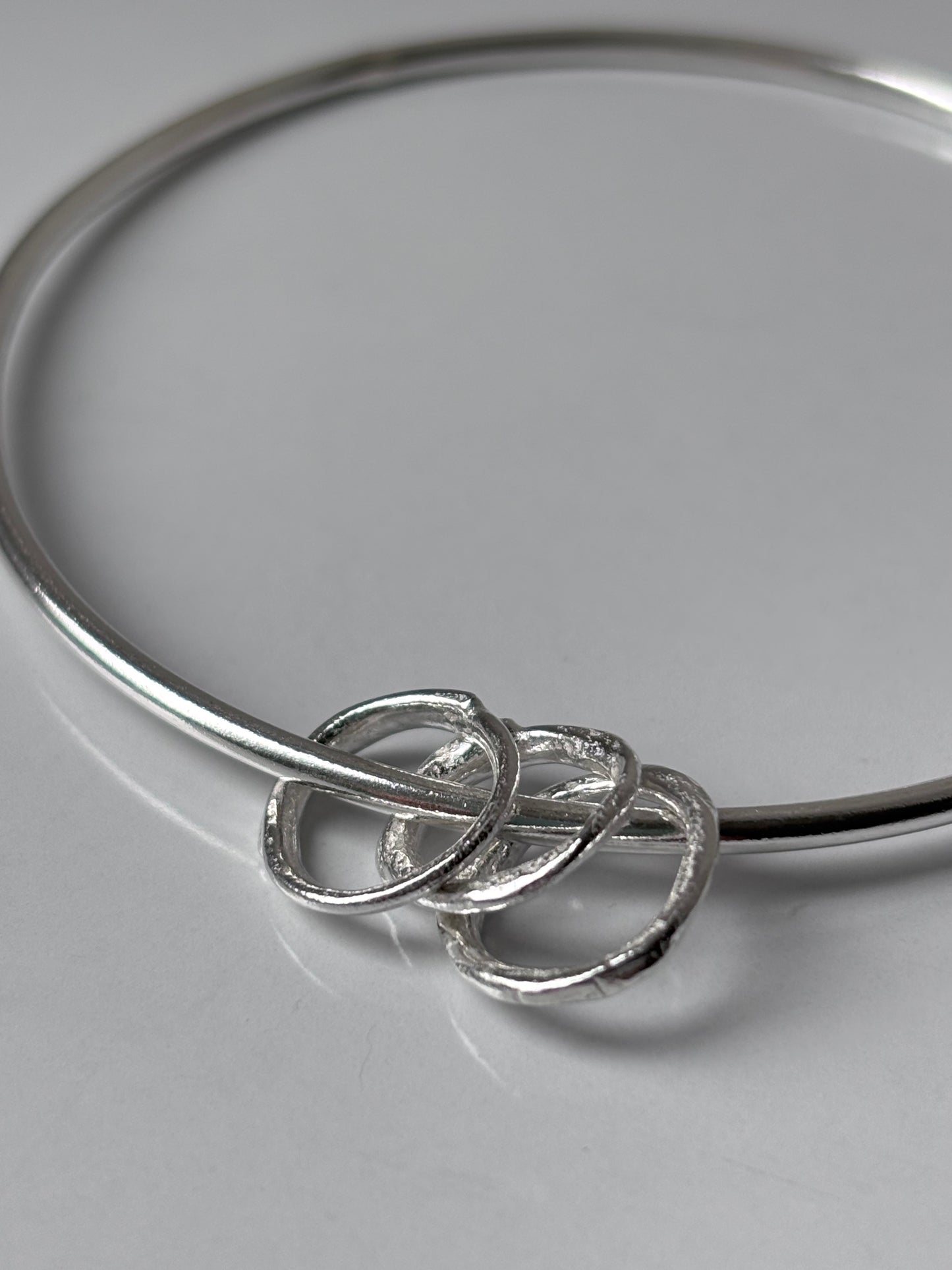 Silver Bangle with Molten Hoop Charms