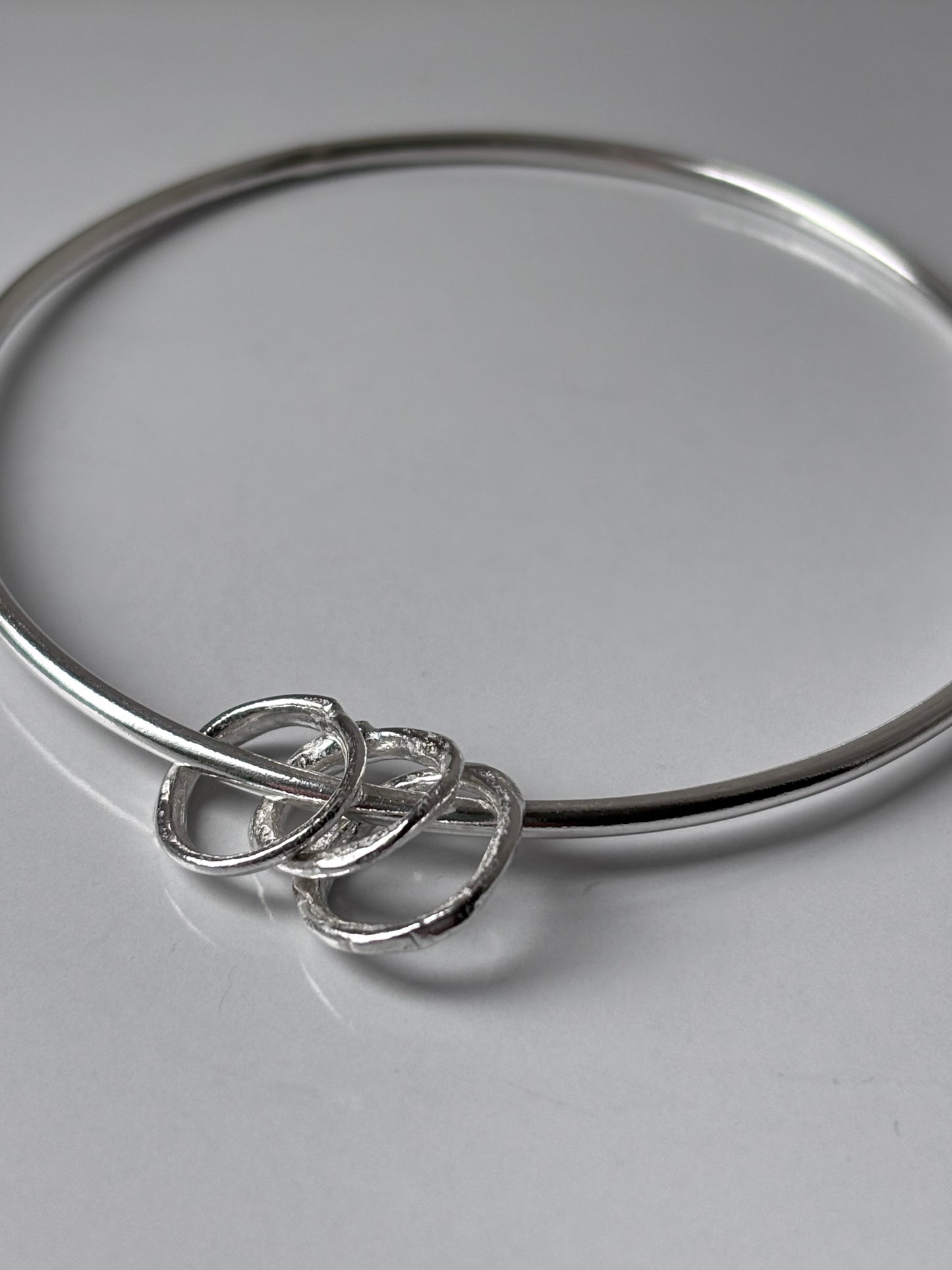 Silver Bangle with Molten Hoop Charms