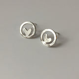 Small silver circle studs with hearts